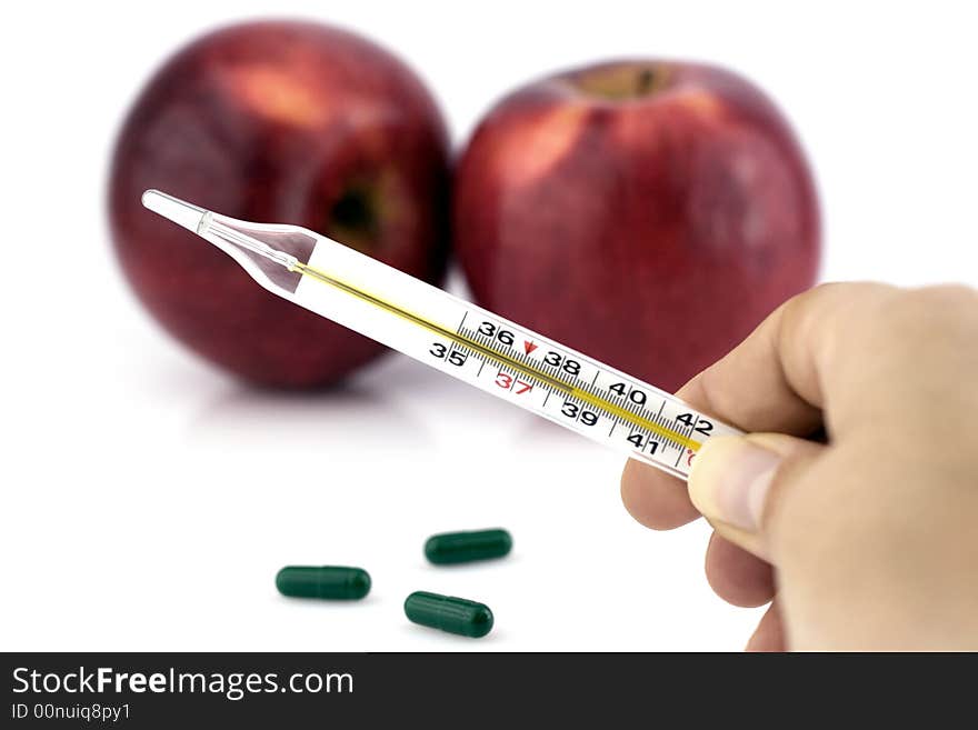 Hand holding thermometer, and two apples on white background. Hand holding thermometer, and two apples on white background