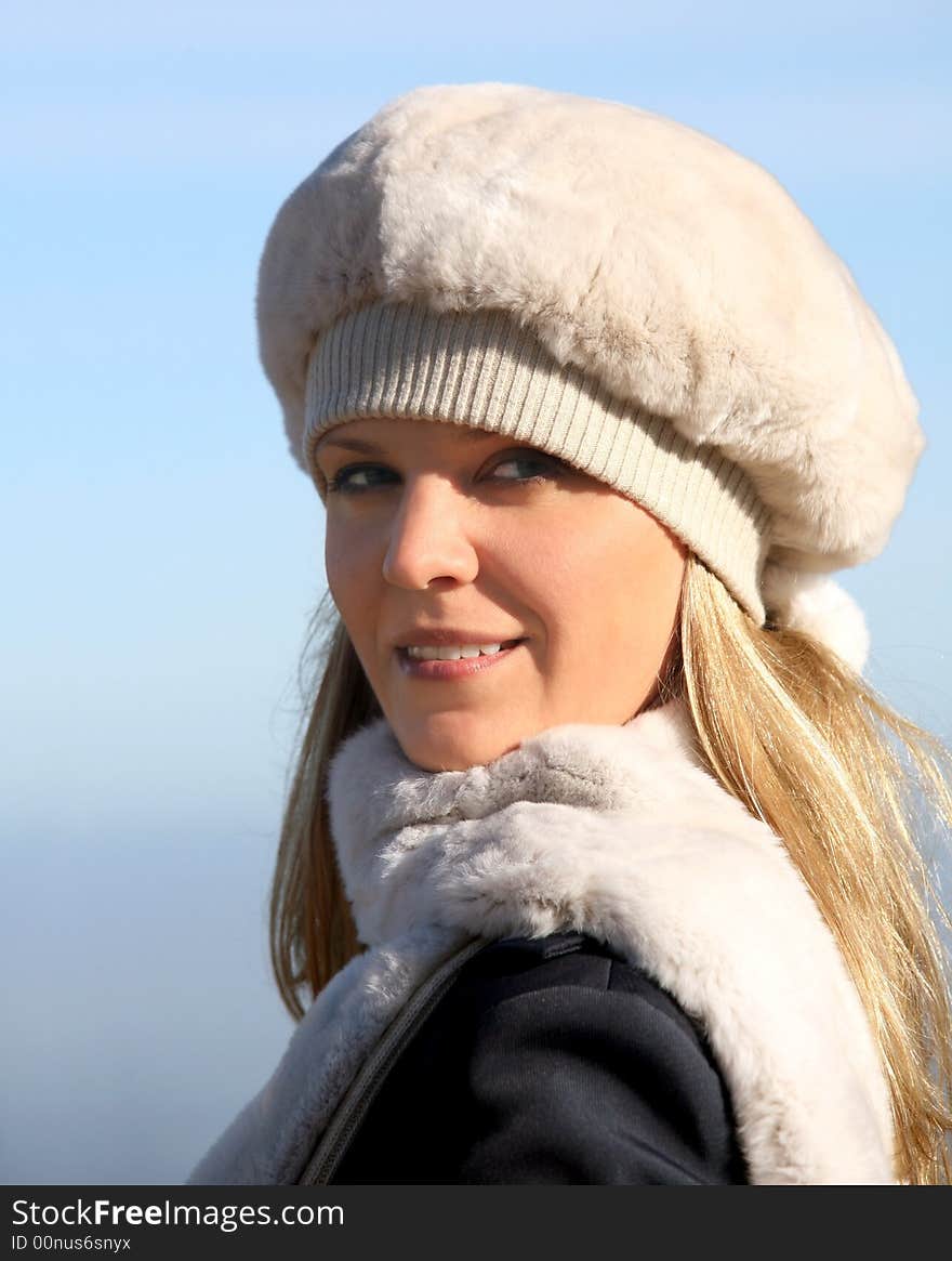 Blond girl in a fur hat and a scarf. Blond girl in a fur hat and a scarf