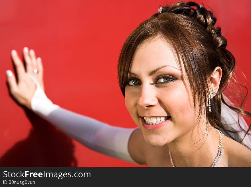 Portrait of beautiful smilign bride on red background. Portrait of beautiful smilign bride on red background.