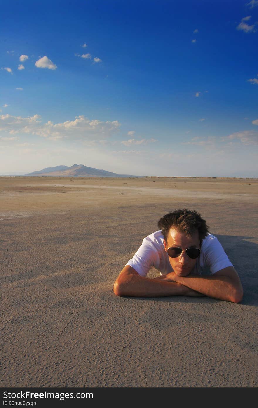 A young man alone in a vast wide open space. A young man alone in a vast wide open space