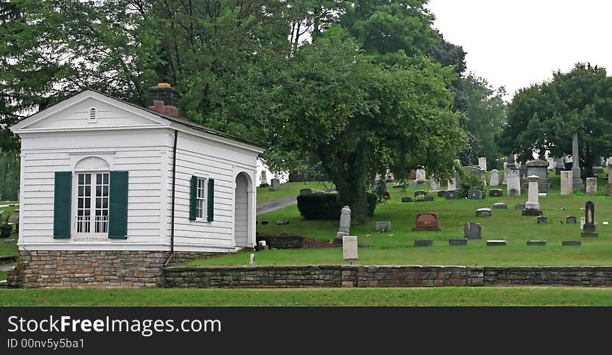 Hillside cemetary with old building and tombstones