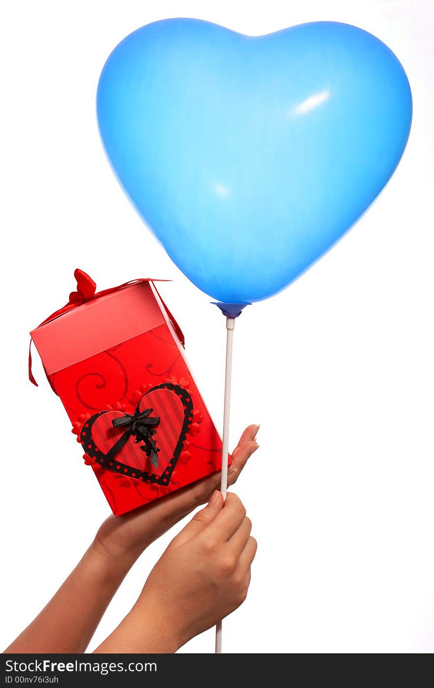 Hands holding a heartshape balloon and a red gift box