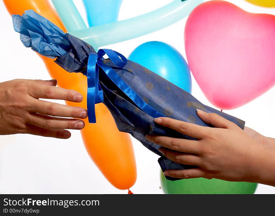 A hand giving gift wrap in blue color. A hand giving gift wrap in blue color