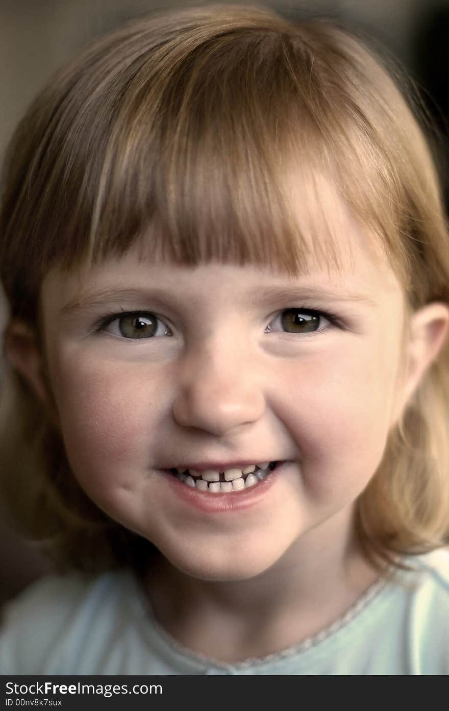 Little girl smiling portrait focused on eyes and face. Little girl smiling portrait focused on eyes and face