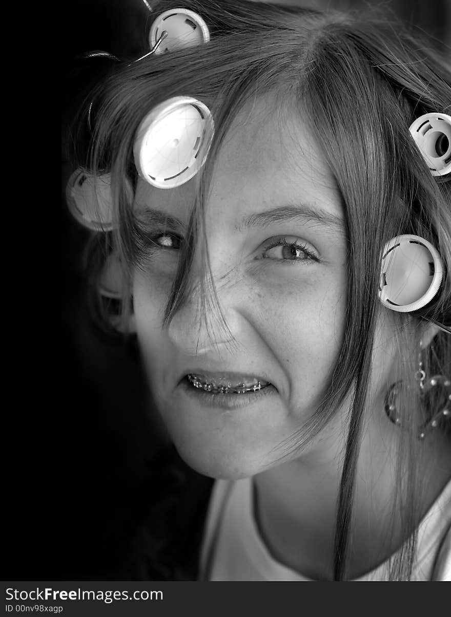 Portrait of teenage girl with curlers in her hair. Portrait of teenage girl with curlers in her hair