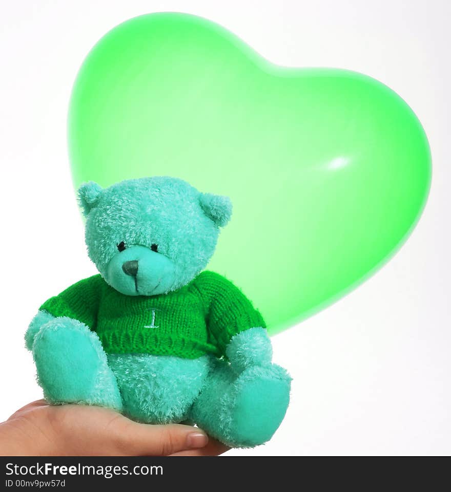 A cute teddy bear and a heart shape balloon