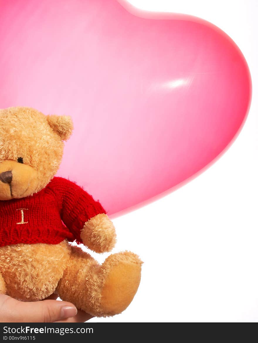 A cute teddy bear and a heart shape balloon