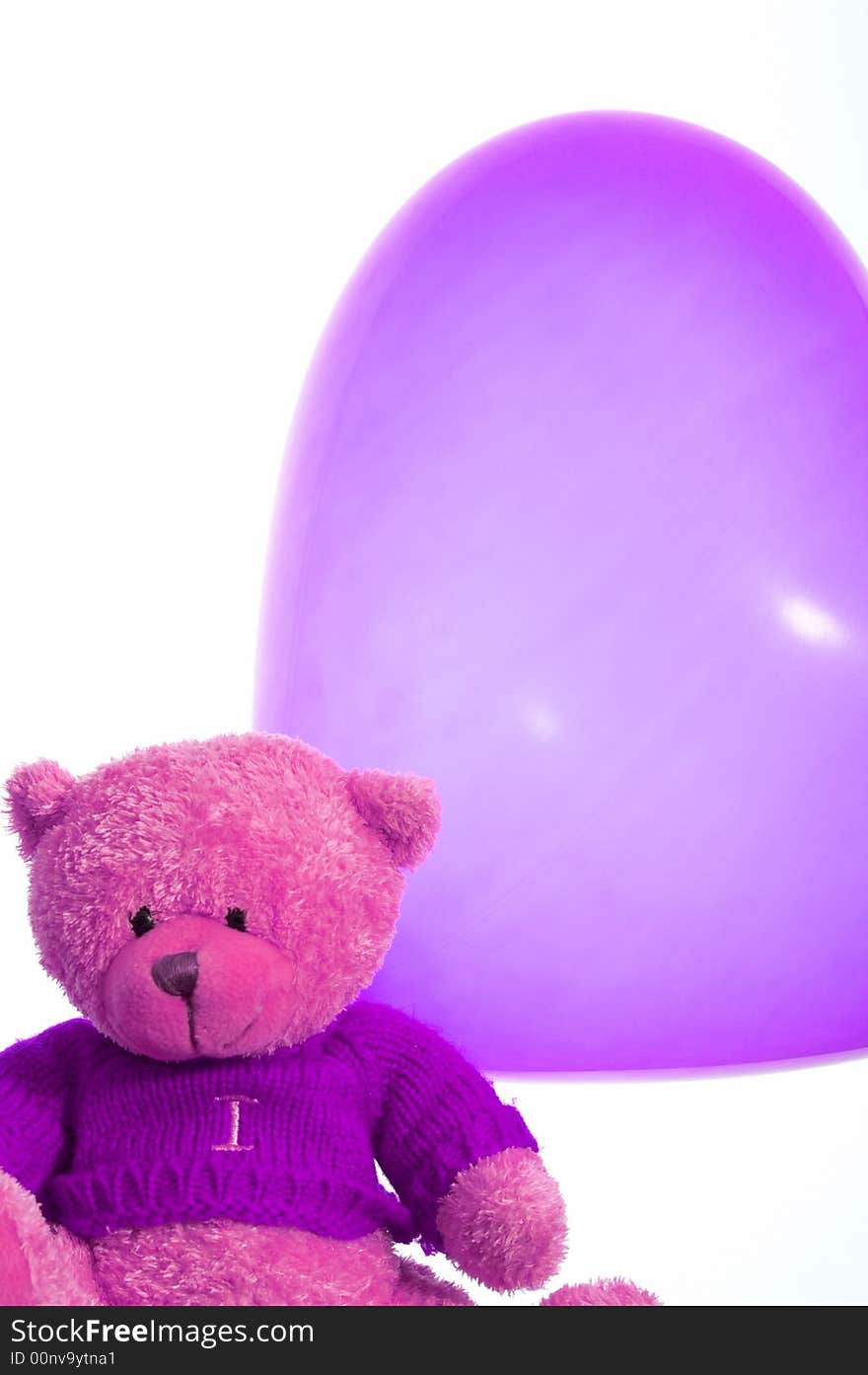 A cute teddy bear and a heart shape balloon