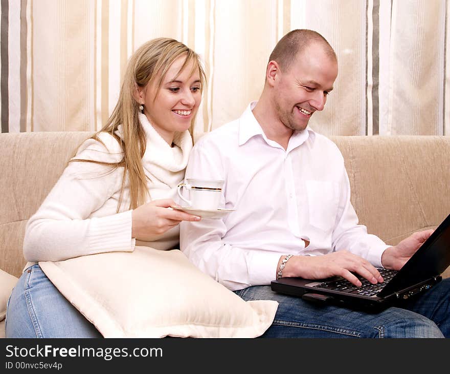 Couple with notebooks on a couch