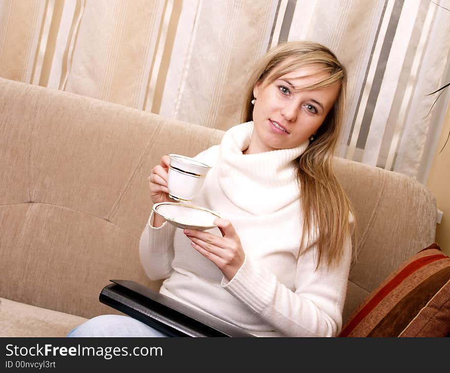 Beautiful woman after work. With folder and coffee on her hand.