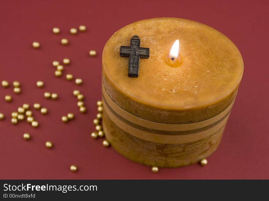 Cross and candle on background