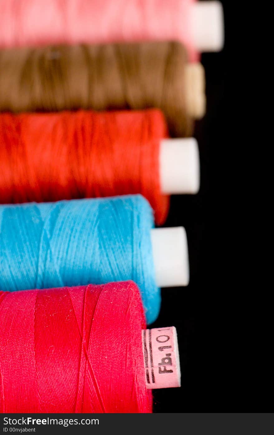 Spools of colorful thread in a row. Spools of colorful thread in a row