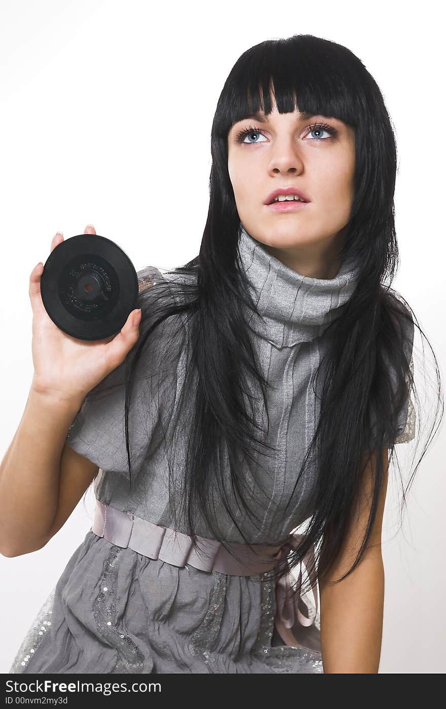 The beautiful brunette with a vinylic plate. The beautiful brunette with a vinylic plate