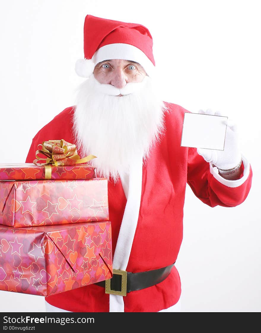 Santa holding a small blank white card and pile gifts. Santa holding a small blank white card and pile gifts.