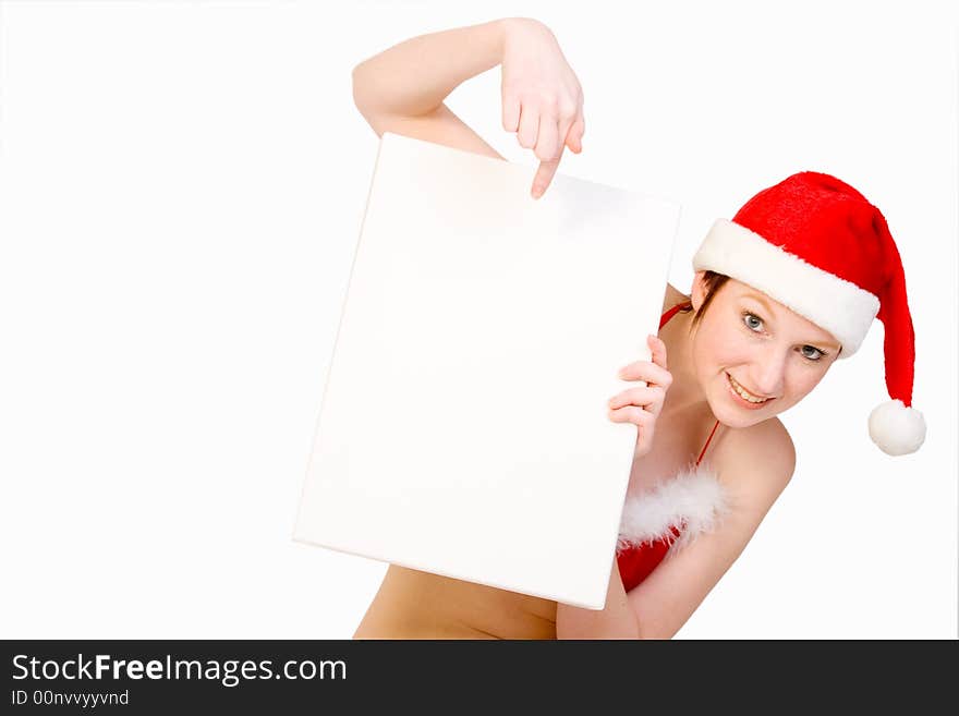 Beautiful girl in christmas bikini and with christmas hat is holding up a white sign for copy space. With background clipping path for your convenience. Beautiful girl in christmas bikini and with christmas hat is holding up a white sign for copy space. With background clipping path for your convenience