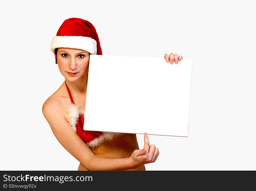 Beautiful girl in christmas bikini and with christmas hat is holding up a white sign for copy space. With background clipping path for your convenience. Beautiful girl in christmas bikini and with christmas hat is holding up a white sign for copy space. With background clipping path for your convenience