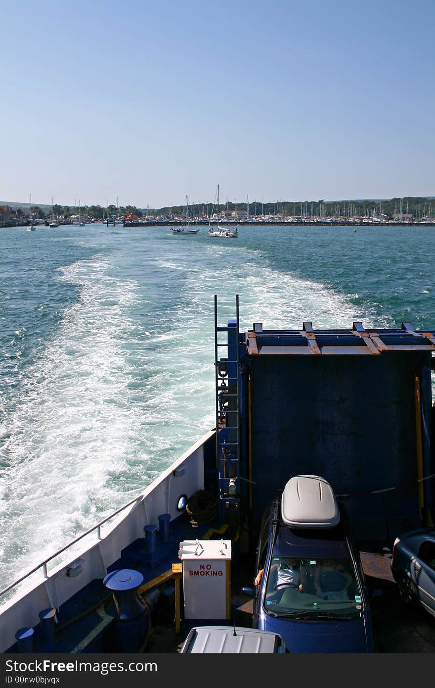 Car ferry leaving port with sea