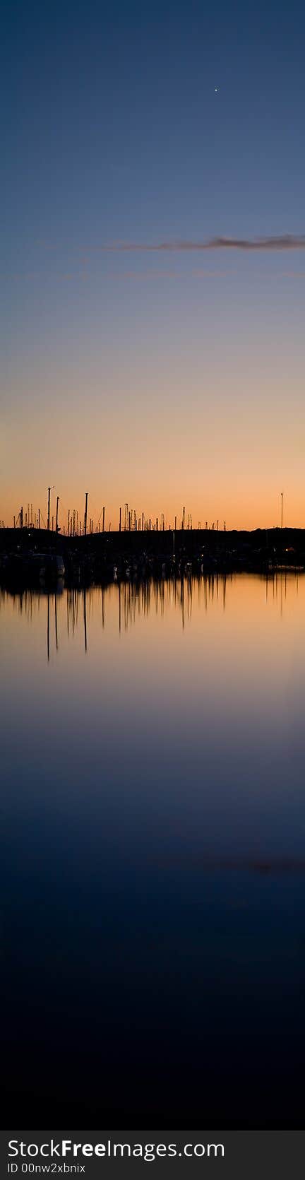 Boats In Harbor At Sunset With Bright Star