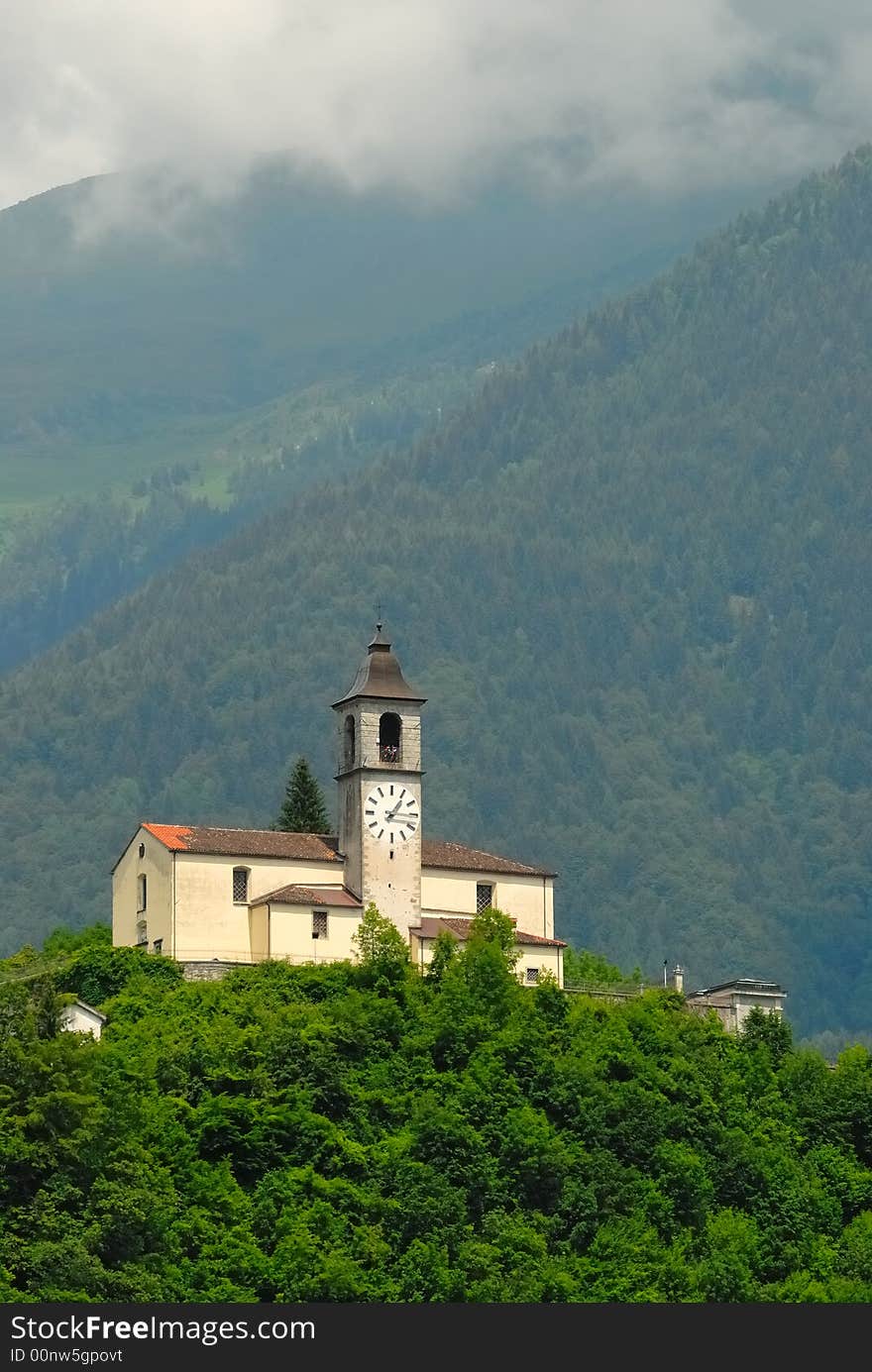 Church on a green hill in the Alps in the north of Italy. Church on a green hill in the Alps in the north of Italy