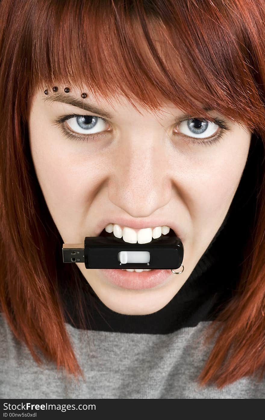 Aggresive girl biting memory stick