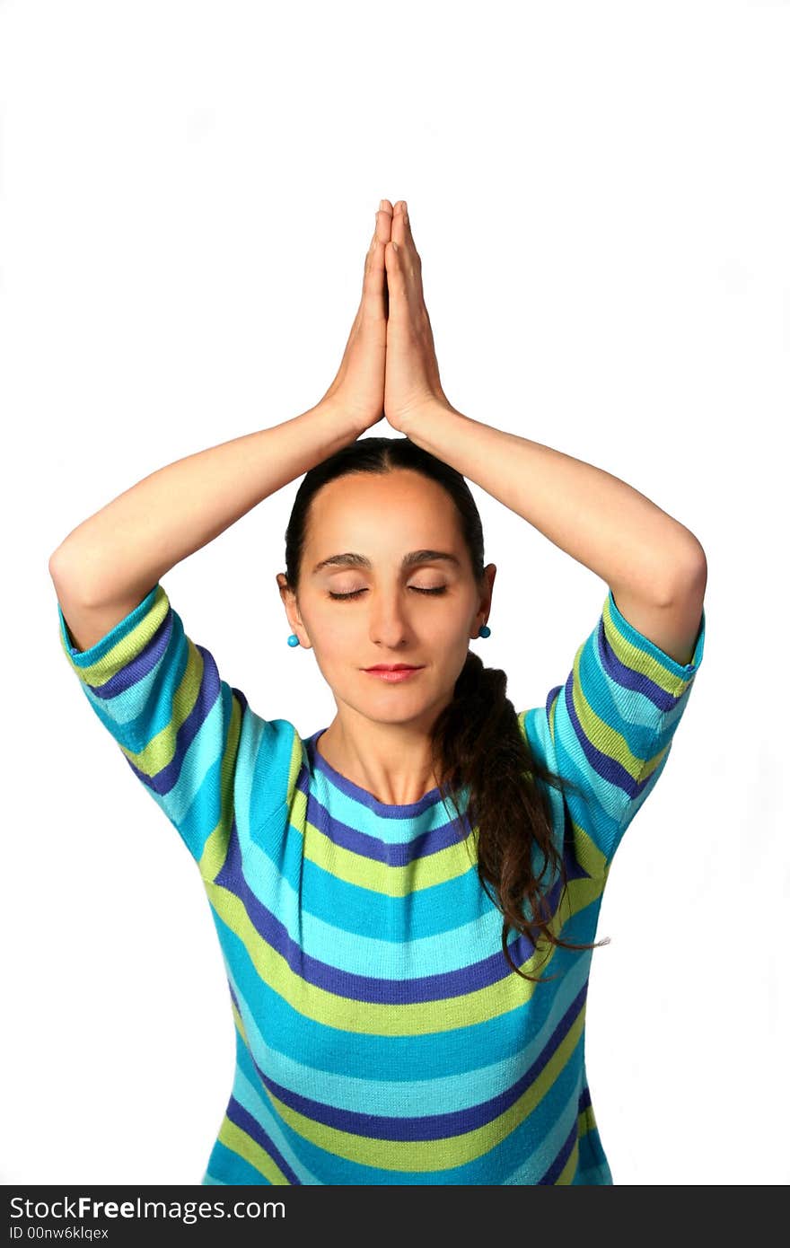 Meditating woman with hands up and eyes closed.