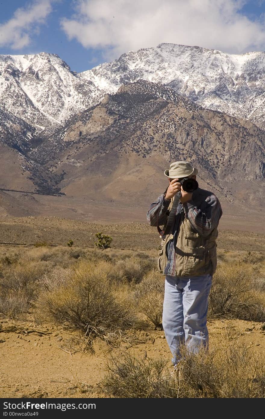 Photographer in the desert taking a photograph