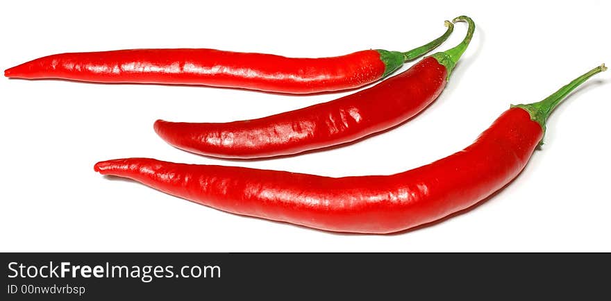 3 isolated red chili peppers against white. 3 isolated red chili peppers against white