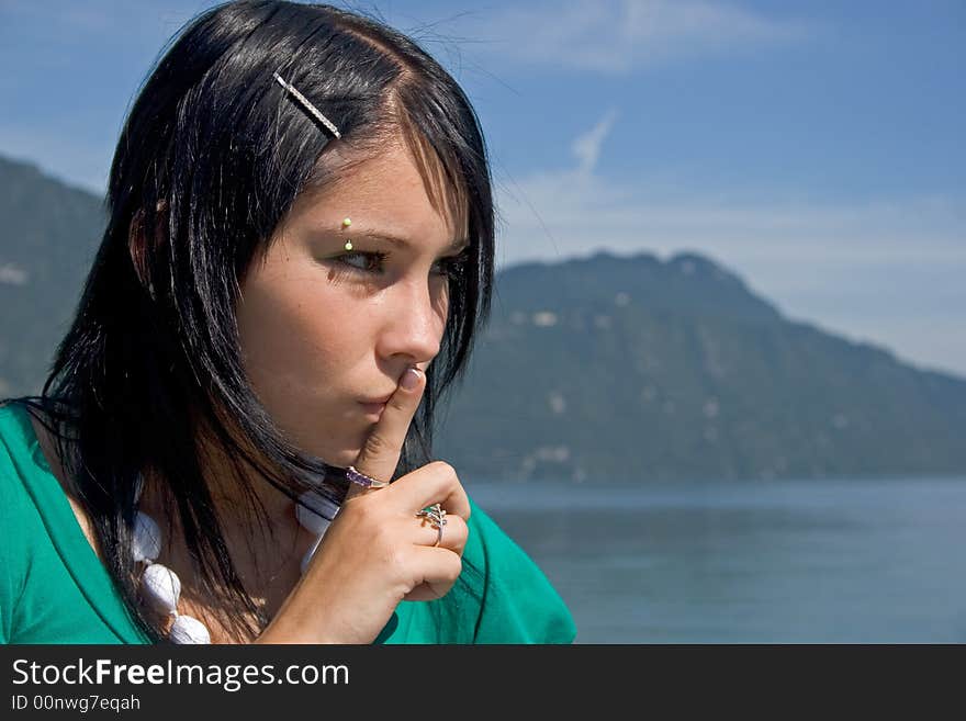 Portrait of a young woman asking for silence