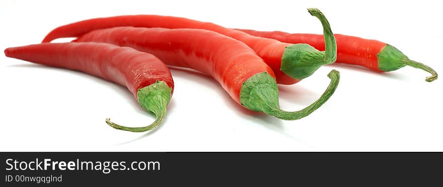 Four red hot cayennes against white background. Four red hot cayennes against white background