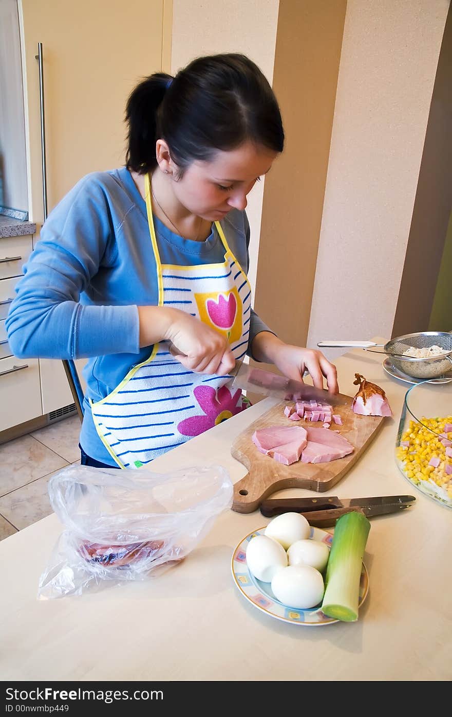 Ham slicing on kitchen desk for layer salad. Ham slicing on kitchen desk for layer salad