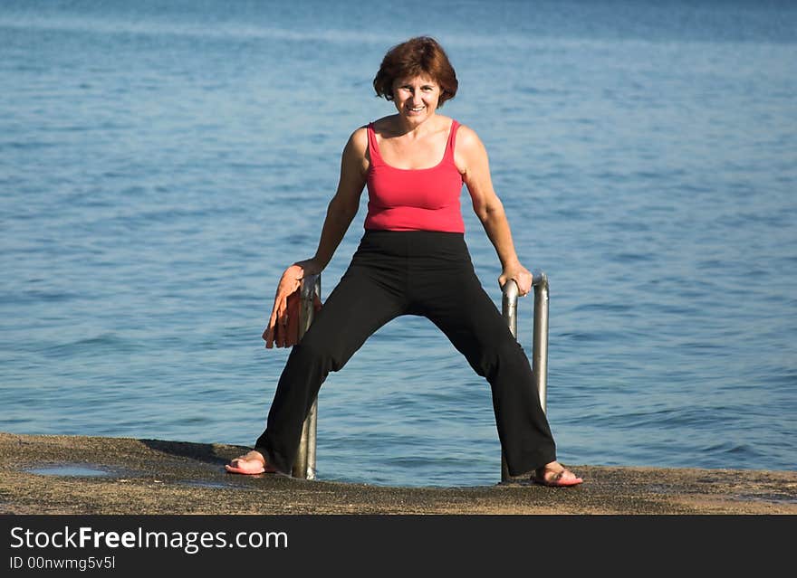 Senior woman making poses on the beach. Senior woman making poses on the beach