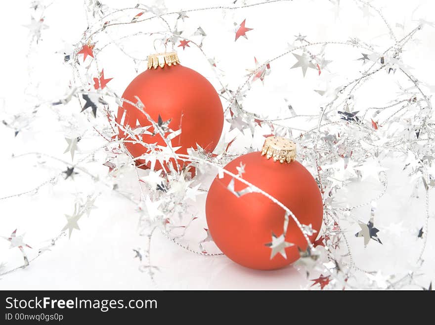 Two red ornaments with stars isolated on a white background