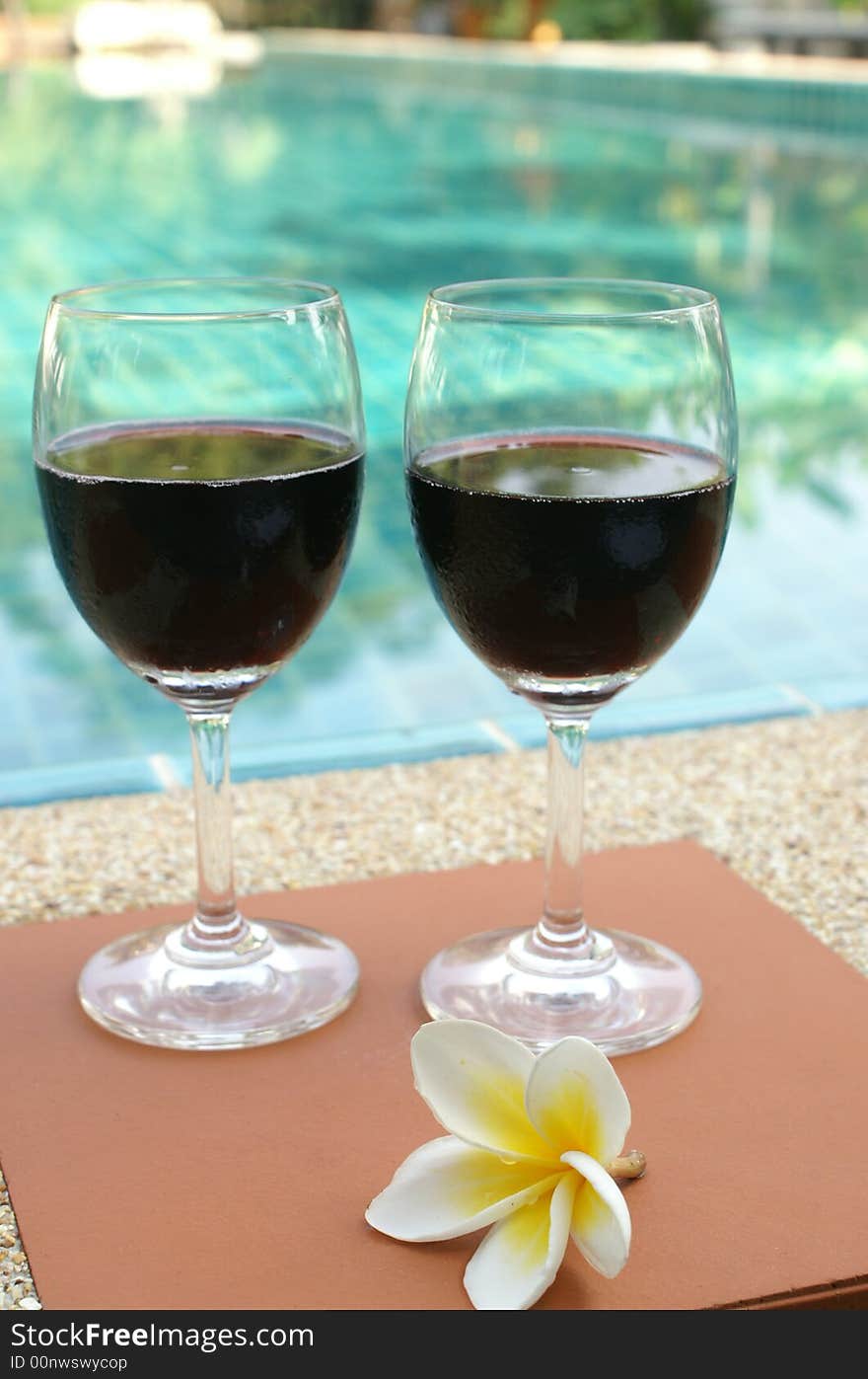 red wine beside swimming pool