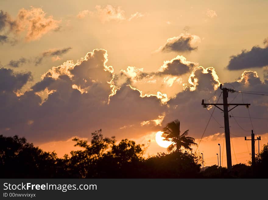 Tropical sunset orange sky dark clouds