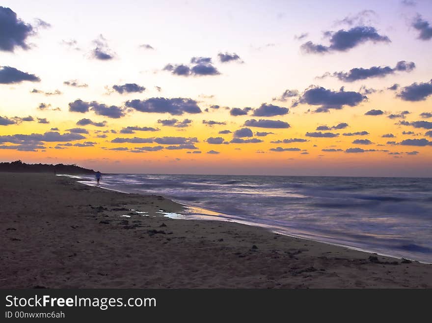 Beach sunset orange glow ocean and waves