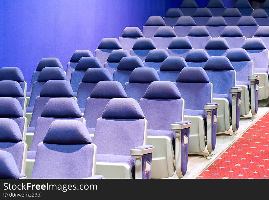 Empty cinema auditorium with blue chairs