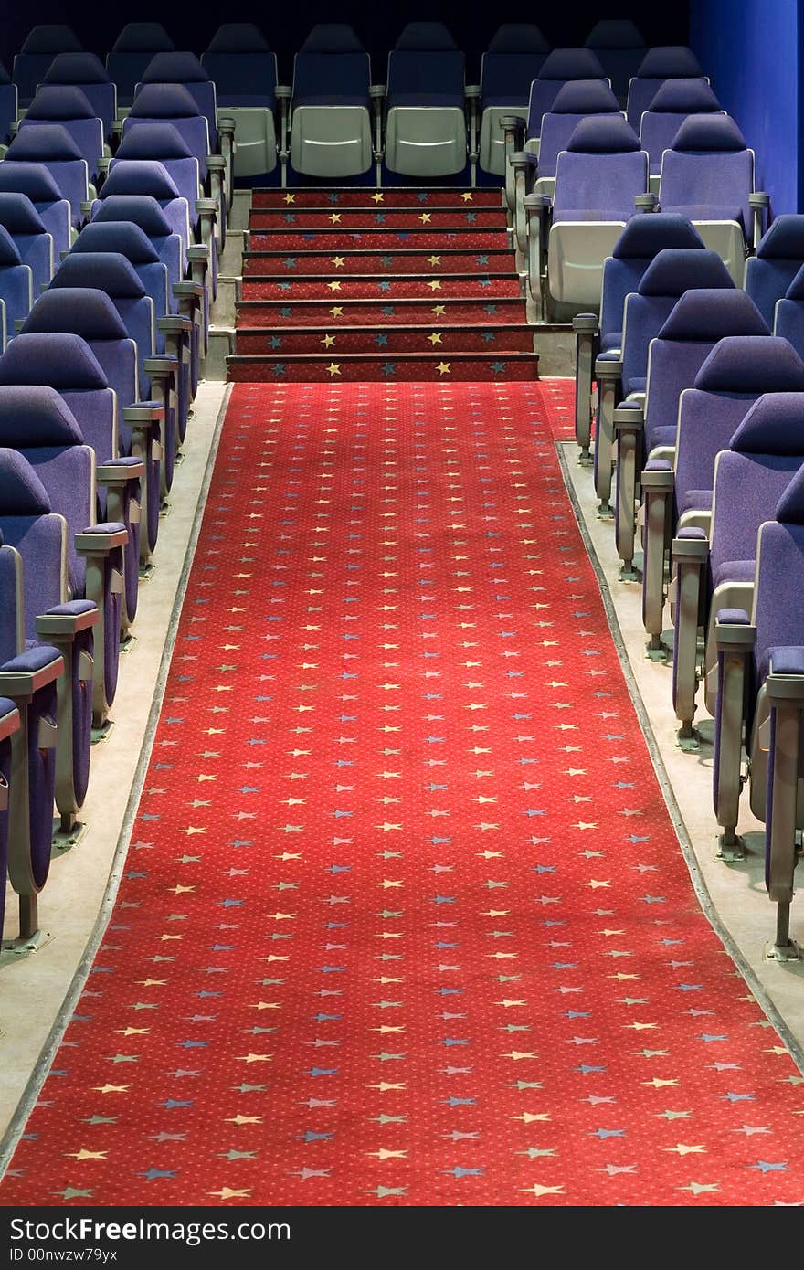 Empty cinema auditorium with blue chairs