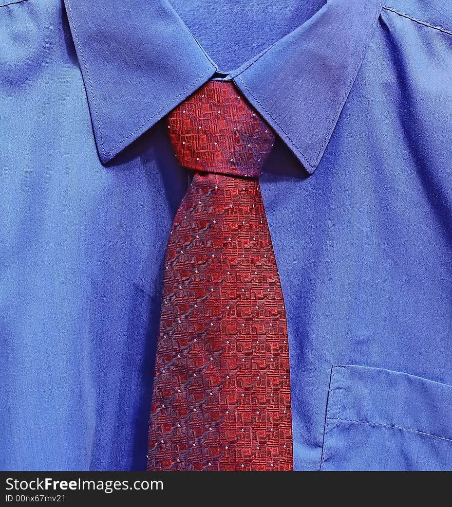 Fragment of masculine clothes. Dark blue shirt and large red tie.