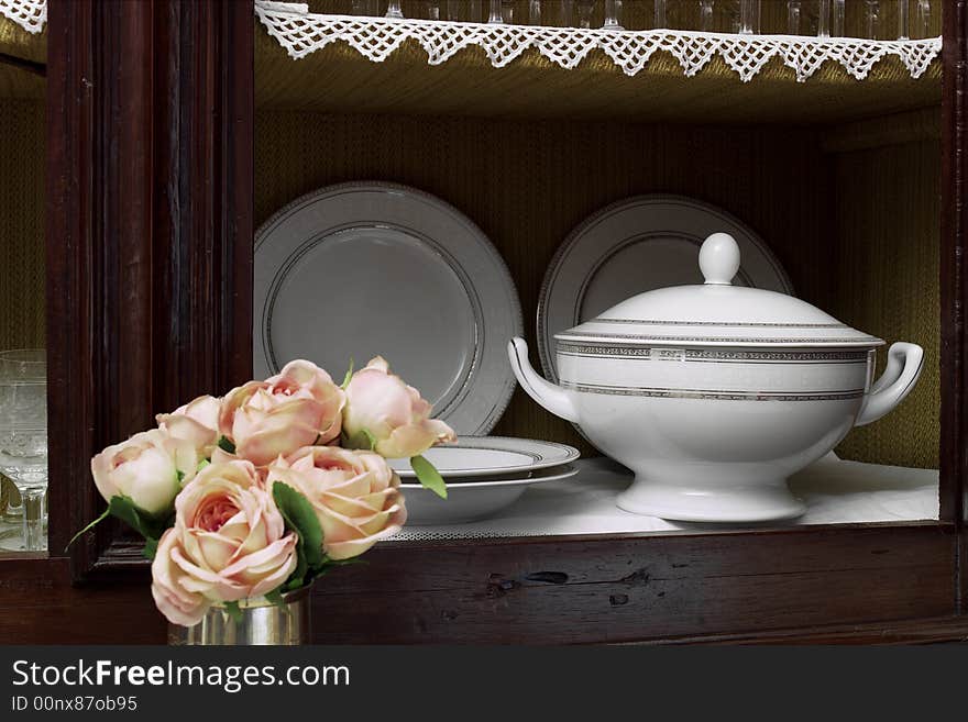 Old style wooden cabinet with crystal glasses dishes and soupier. Old style wooden cabinet with crystal glasses dishes and soupier