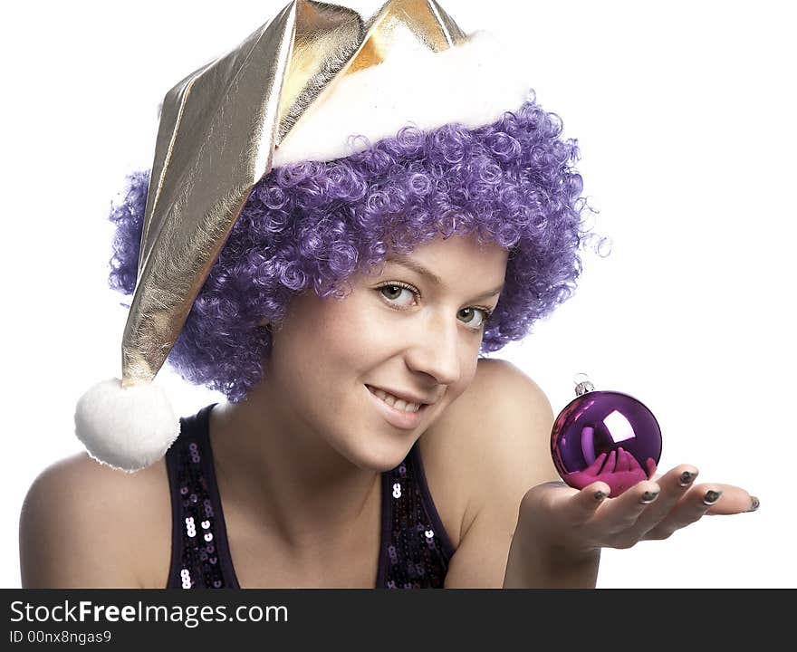 Girl in santa's hat and purple wig with christmas ball. Girl in santa's hat and purple wig with christmas ball