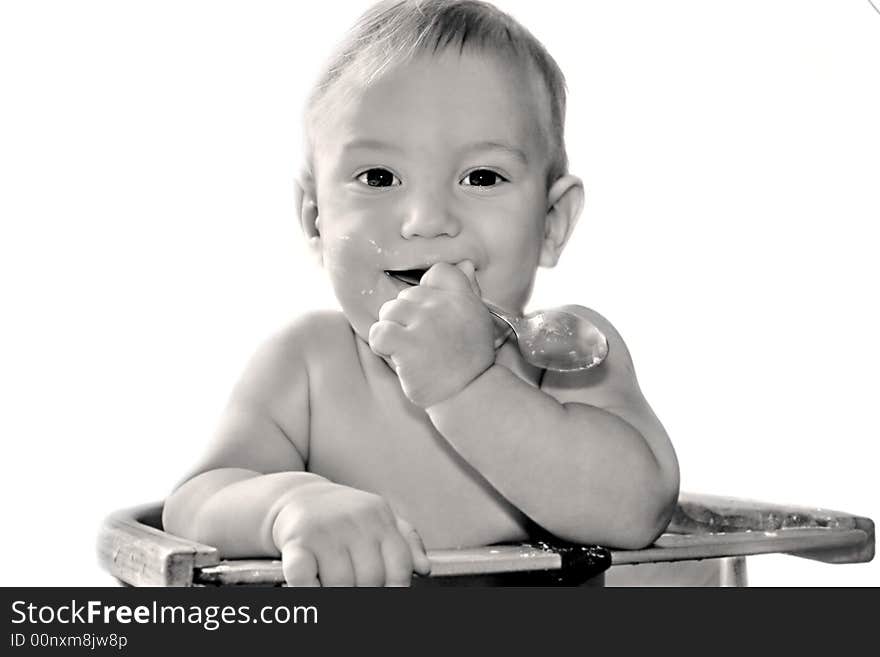 Baby boy eating himself over white