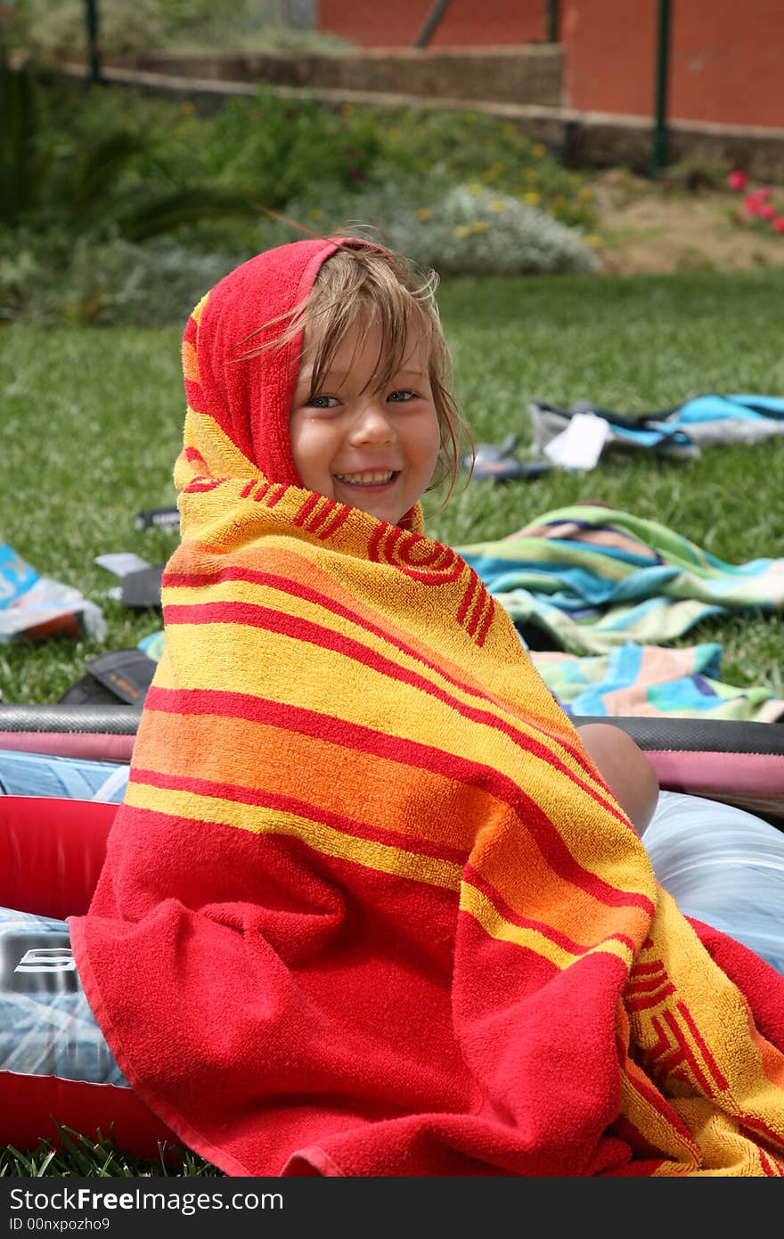 A young girl wrapped up in a towel. A young girl wrapped up in a towel