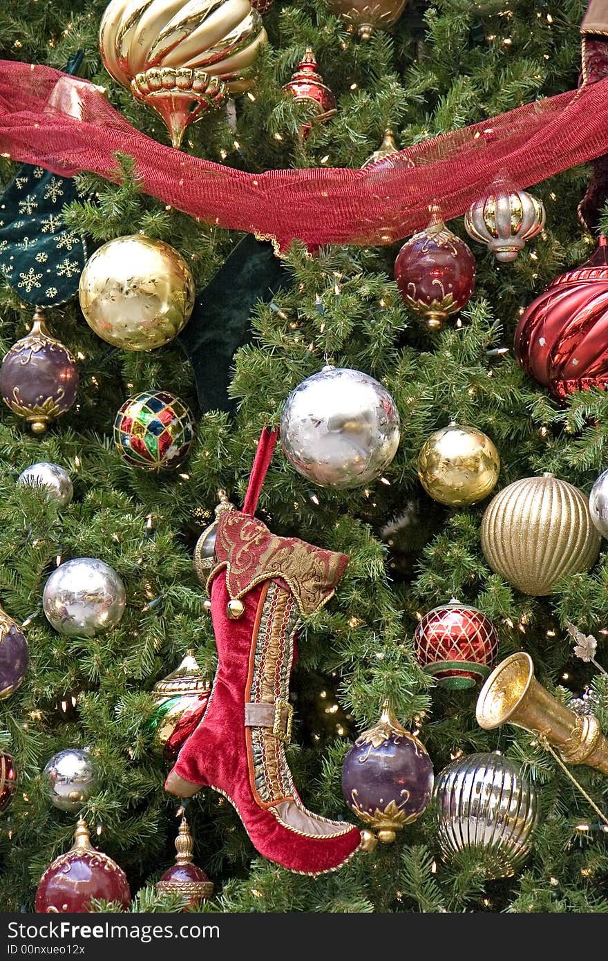 A decorated Christmas tree with balls, ribbons and an elf boot. A decorated Christmas tree with balls, ribbons and an elf boot