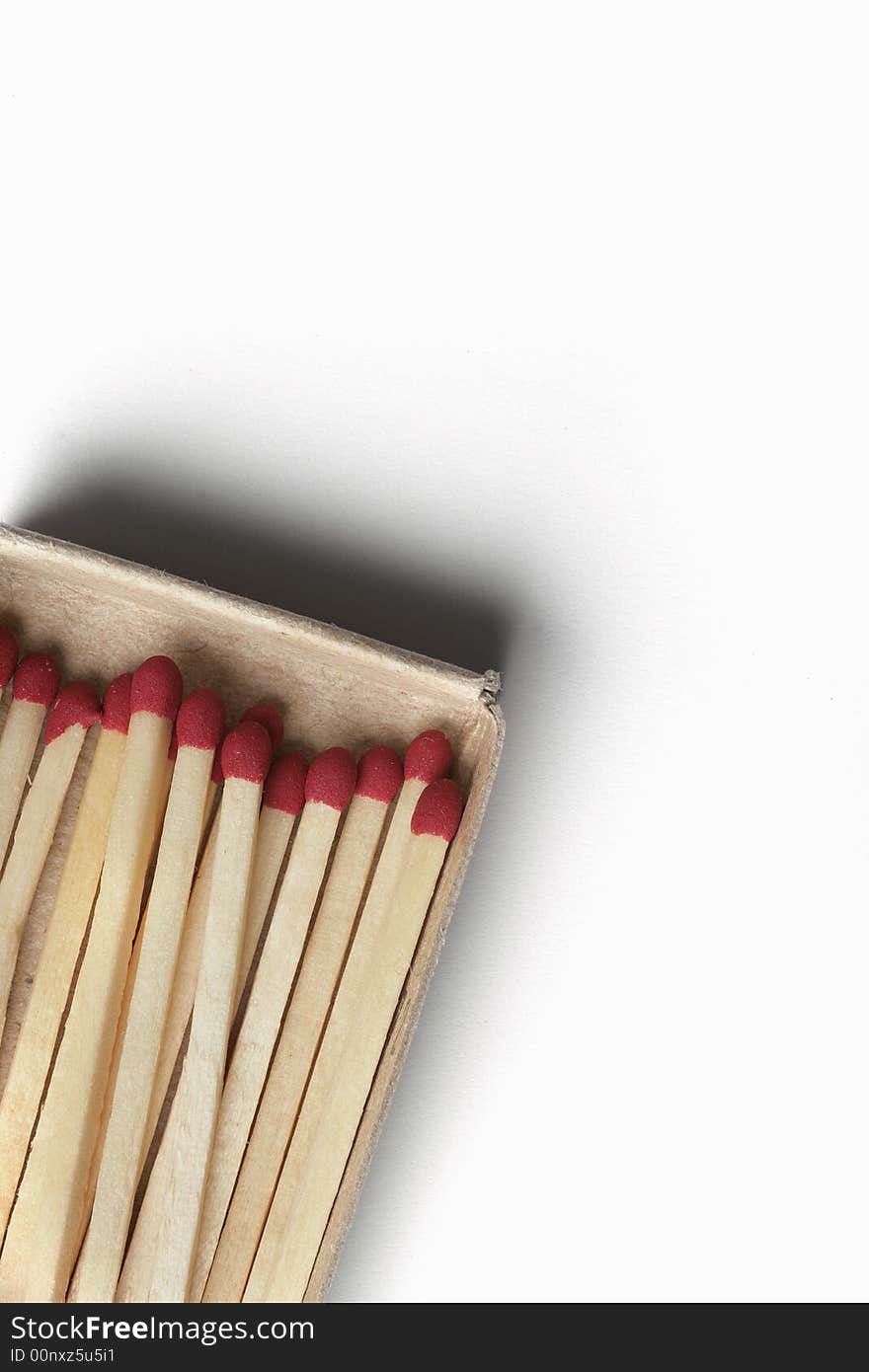 Matchsticks in matchbox cropped on angle isolated on white background