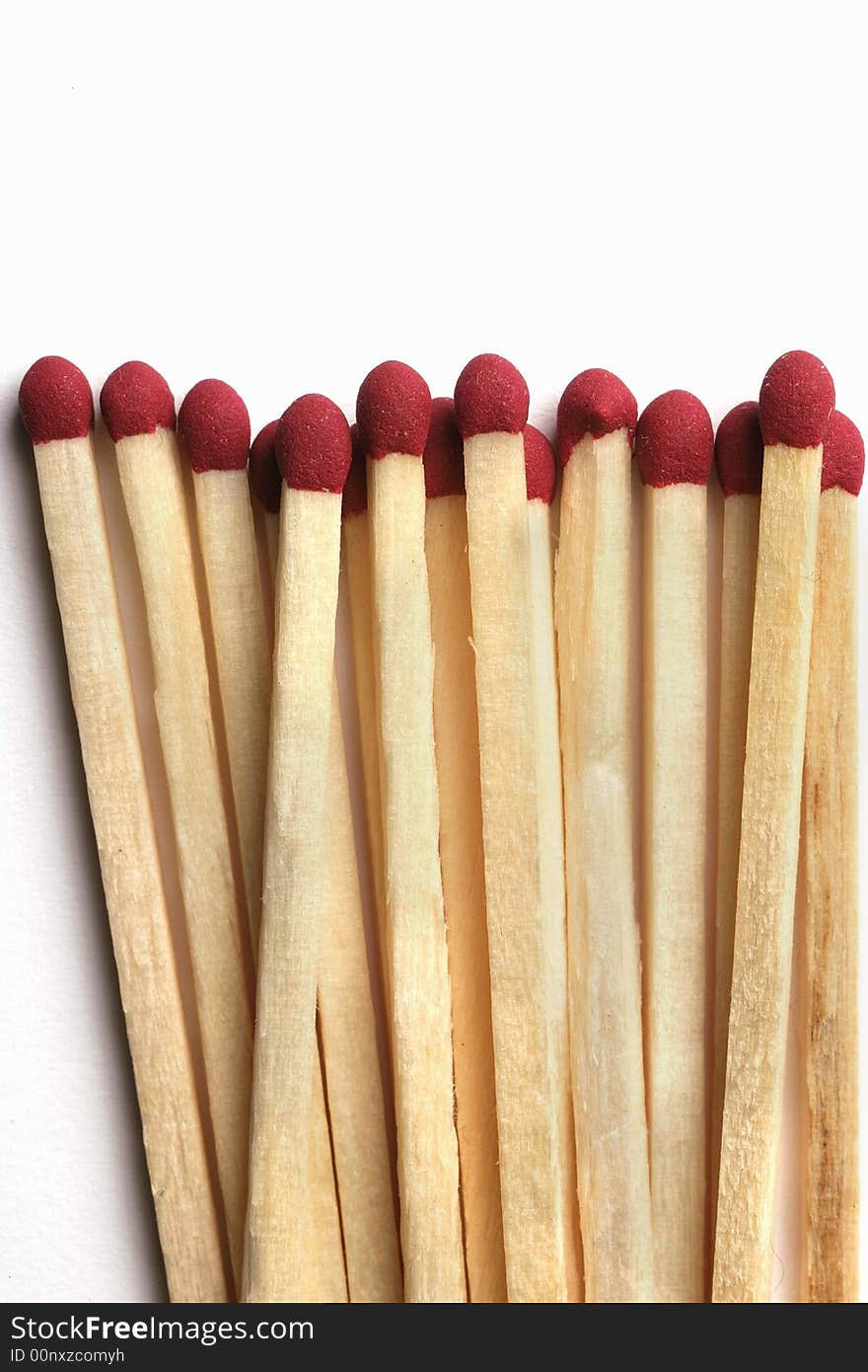 Wooden Matchsticks with red sulfur tips isolated on white background