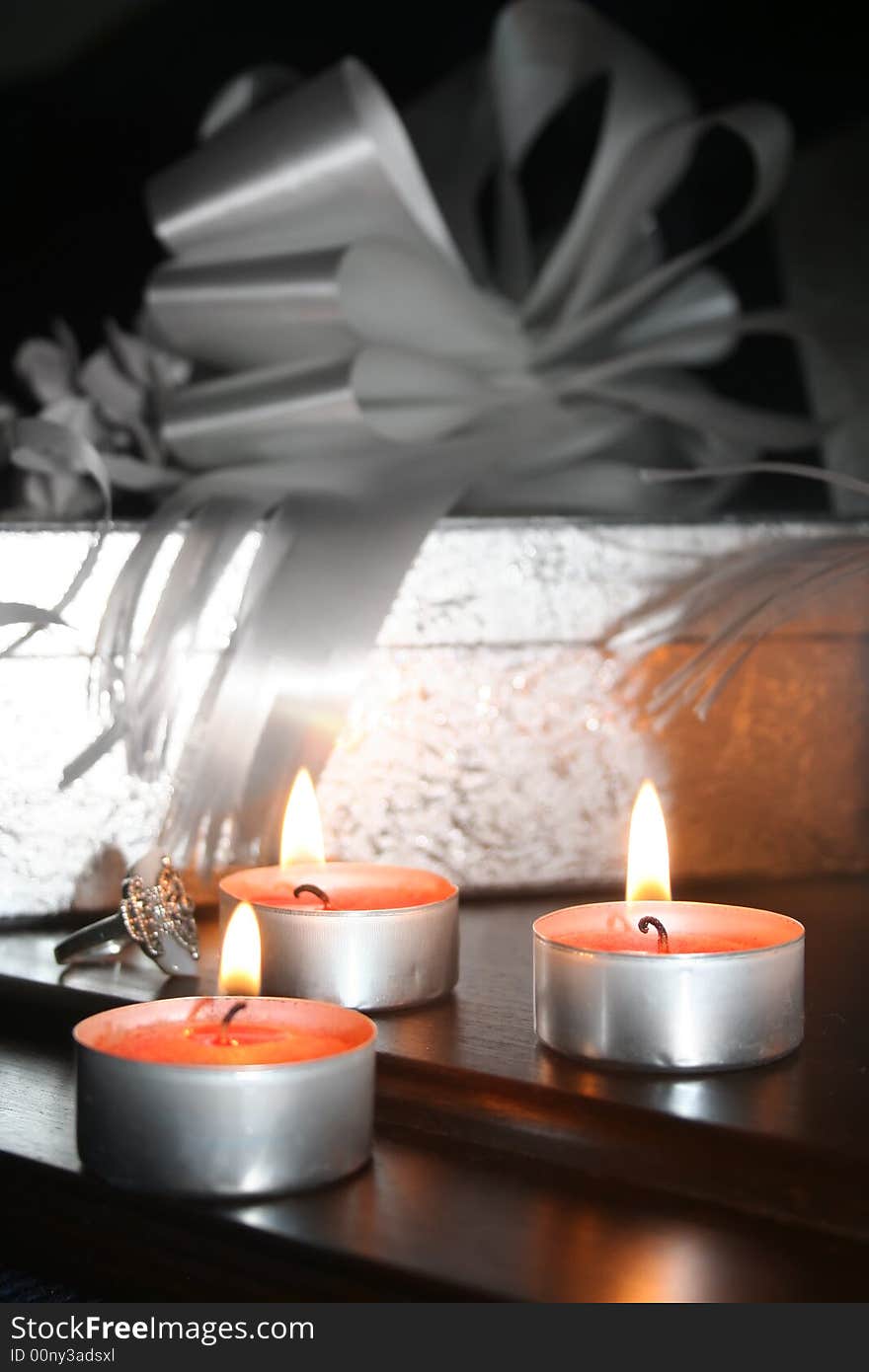 Three candles, silver box and decorative bows