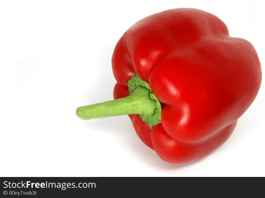 Isolated nice big red paprika with green tail against white. Isolated nice big red paprika with green tail against white