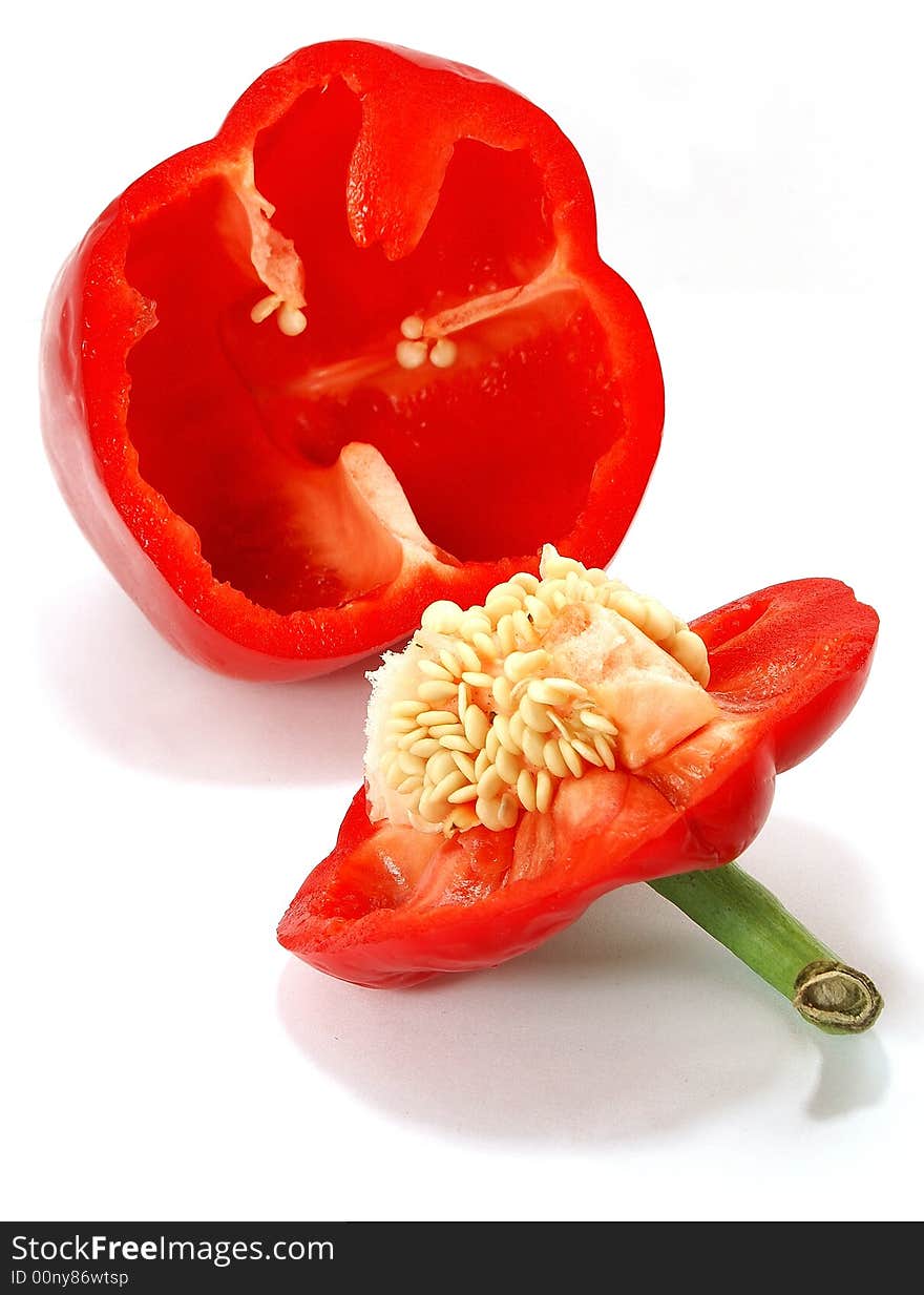 Isolated big nice slit red paprika with seeds against white. Isolated big nice slit red paprika with seeds against white