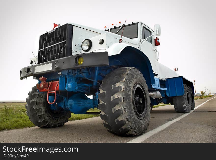 White powerful airport auxiliary tractor awaiting orders