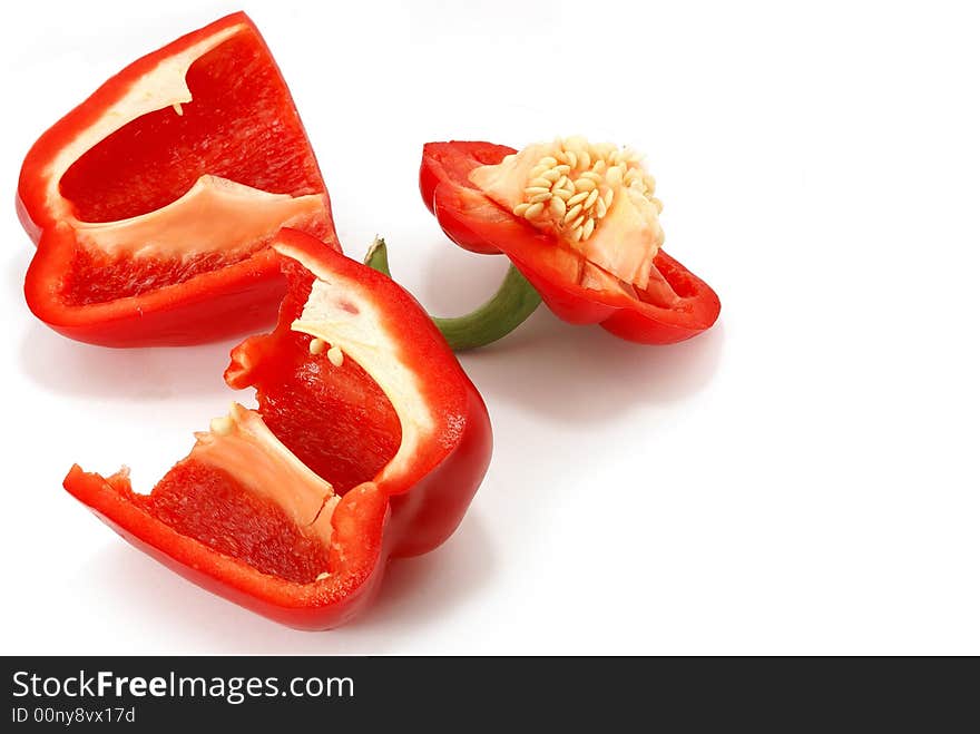 Isolated slit red paprika with seed against white. Isolated slit red paprika with seed against white